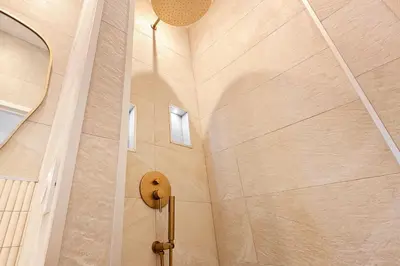 a shower in a room with a large wall at The Palm - 5mn Palais - Croisette - Beaches in Cannes