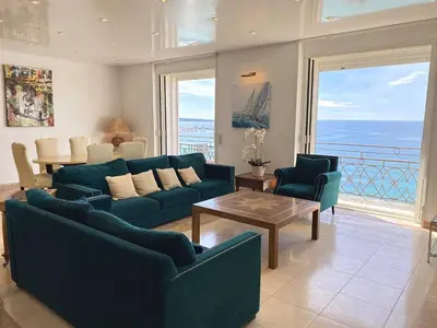 a living room with two blue couches and a table at Cannes Croisette - Appartement 5 pièces face mer in Cannes