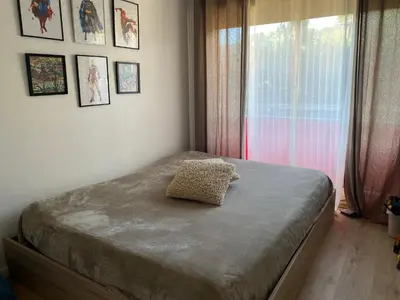 a small bedroom with a bed with a window at Appartement 45m2 - 4 couchages - Proche Cannes -plages à 2km -wifi rapide in Le Cannet