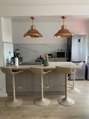a kitchen with two bar stools and two lights at Appartement 45m2 - 4 couchages - Proche Cannes -plages à 2km -wifi rapide in Le Cannet