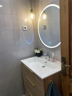 a bed with two pillows on it in a room at Appartement 45m2 - 4 couchages - Proche Cannes -plages à 2km -wifi rapide in Le Cannet