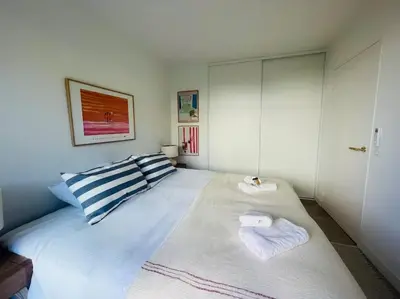 a bedroom with a bed with two towels on it at Le Bluebay - Luxurious 2 bedrooms seaview swimming pool carpark in Cannes