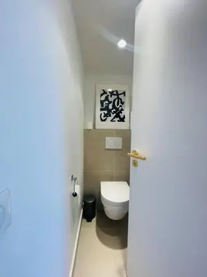 a bathroom with a white toilet in a room at Le Bluebay - Luxurious 2 bedrooms seaview swimming pool carpark in Cannes