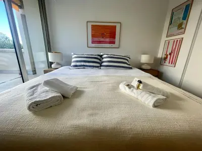 a bedroom with a bed with towels on it at Le Bluebay - Luxurious 2 bedrooms seaview swimming pool carpark in Cannes