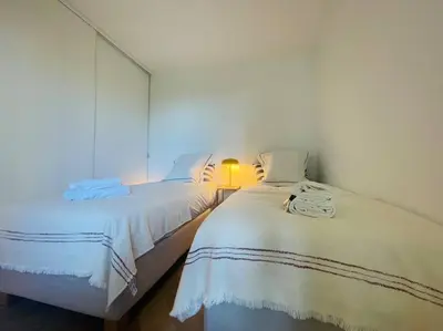 two beds sitting next to each other in a room at Le Bluebay - Luxurious 2 bedrooms seaview swimming pool carpark in Cannes
