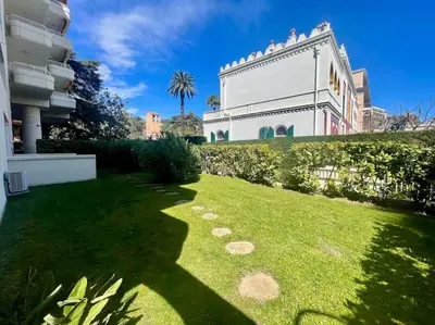 a large white building with a grass yard at Le Bluebay - Luxurious 2 bedrooms seaview swimming pool carpark in Cannes