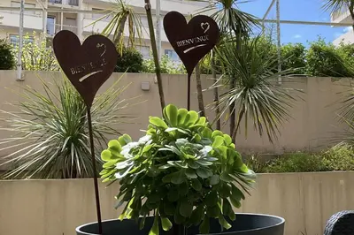 two hearts signs in a pot with a plant at Charming refurbished cocoon with swimming pool in Cannes