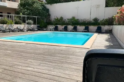 a swimming pool with lounge chairs around it at Charming refurbished cocoon with swimming pool in Cannes