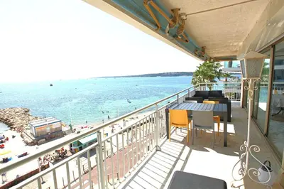 a balcony with a view of the beach and the ocean at AMAZING SEA VIEW APARTMENT in Cannes