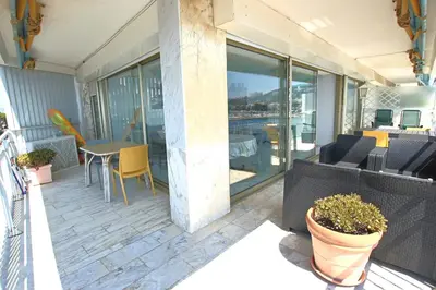 a patio with a table and chairs on a balcony at AMAZING SEA VIEW APARTMENT in Cannes