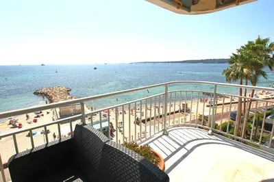a balcony with a view of the beach and the ocean at AMAZING SEA VIEW APARTMENT in Cannes