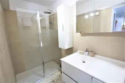 a bathroom with a shower and a white sink at AMAZING SEA VIEW APARTMENT in Cannes