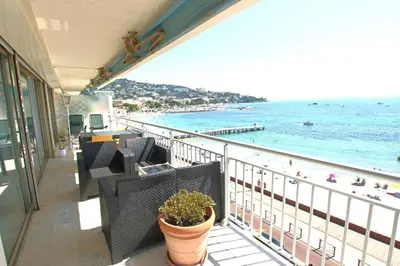 a balcony with chairs and a view of the beach at AMAZING SEA VIEW APARTMENT in Cannes