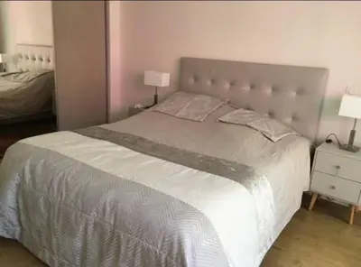 a bedroom with a large bed and two lamps at 3 Pièces avec grand Jardin in Cannes