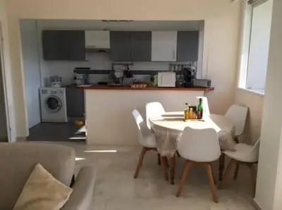 a kitchen and a table and chairs in a room at 3 Pièces avec grand Jardin in Cannes