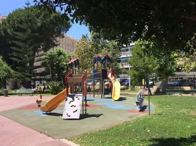 a playground with slides in a park at 2 pièces avec piscine, 150 m de la plage. in Cannes