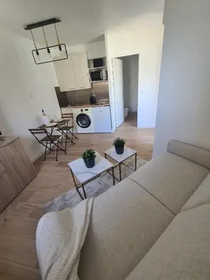a living room with a couch and a kitchen at BOCCA CABANA in Cannes