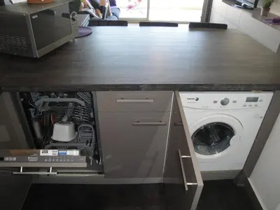 a kitchen with a washer and dryer under a counter at Superbe vue mer à 50 mètres des plages in Cannes