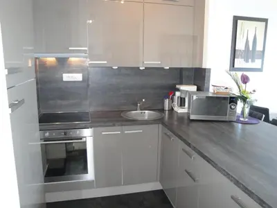 a kitchen with a sink and a microwave at Superbe vue mer à 50 mètres des plages in Cannes