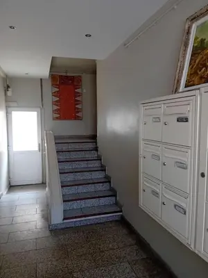 a staircase in a room with a door and a stair case at Chambre d hôte artistique cannes in Cannes