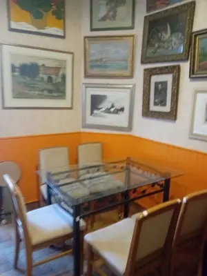 a dining room with a glass table and chairs at Chambre d hôte artistique cannes in Cannes