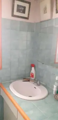 a bathroom with a sink with a bottle on it at Chambre d hôte artistique cannes in Cannes