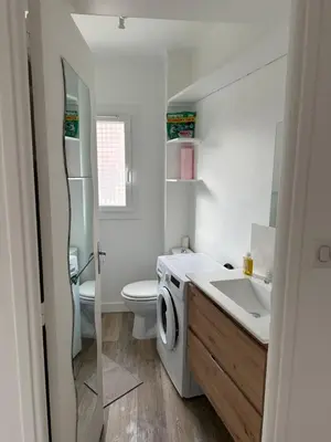 a bathroom with a sink and a washing machine at Appartement Cannes in Cannes
