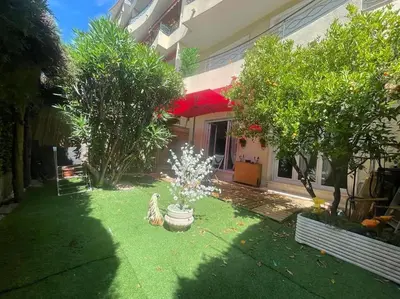 a yard with a fountain in front of a house at Cannes Cosy Oasis in Cannes