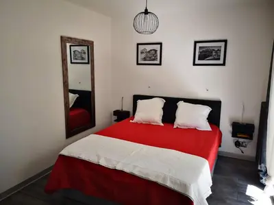 a bedroom with a red and white bed and a mirror at Cannes Cosy Oasis in Cannes