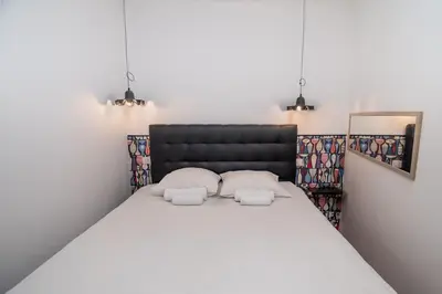 a bedroom with a large bed with two pillows at Merveilleux appartement - Proche de la Croisette ! in Cannes