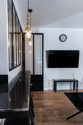 a living room with a tv and a table at Merveilleux appartement - Proche de la Croisette ! in Cannes