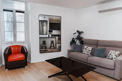 a living room with a couch and a table at Merveilleux appartement - Proche de la Croisette ! in Cannes