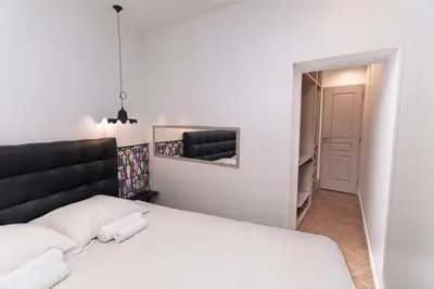 a bedroom with a white bed and a mirror at Merveilleux appartement - Proche de la Croisette ! in Cannes
