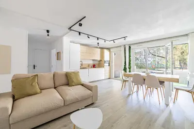 a living room with a couch and a table at Comfort and serenity with A-C, Parking and Balcony in Cannes