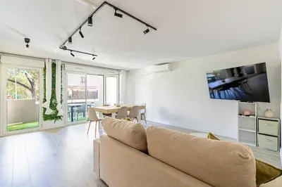 a living room with a couch and a table at Comfort and serenity with A-C, Parking and Balcony in Cannes