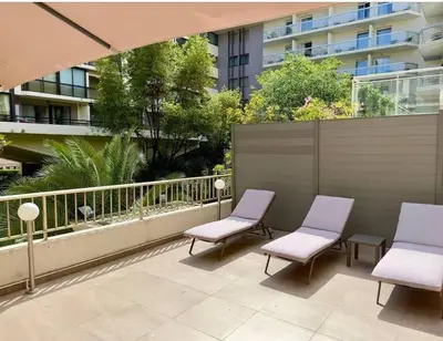a balcony with two chairs and a fence at Sweet home+terrasse de 60m2 ,2 mn from croisette beach in Cannes