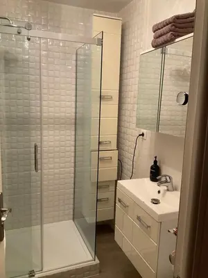 a bathroom with a glass shower and a sink at Sweet home+terrasse de 60m2 ,2 mn from croisette beach in Cannes
