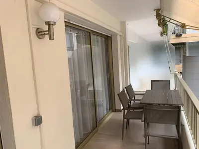 a dining room with a table and chairs on a balcony at Sweet home+terrasse de 60m2 ,2 mn from croisette beach in Cannes
