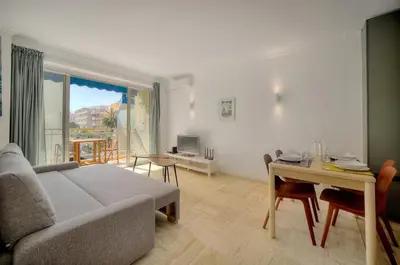 a living room with a couch and a table at Immogroom - cosy apartment - Terrace - AC - Wifi in Cannes