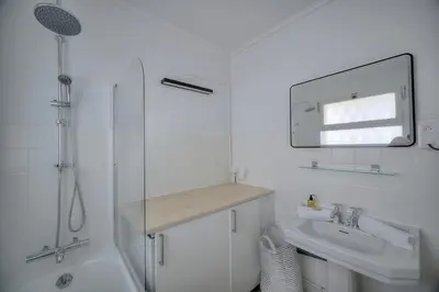 a white bathroom with a sink and a shower at Immogroom - cosy apartment - Terrace - AC - Wifi in Cannes