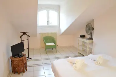 a living room with a table and a blue couch at Appartement vue mer proches plages et congrès in Cannes
