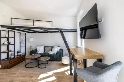 a living room with a bunk bed and a couch at 34 BORNIOL - Bel appartement rénové avec mezzanine Cannes in Cannes