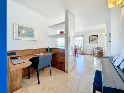 a kitchen with a desk and a dining room at Rooftop Grande terrasse Vue mer in Cannes