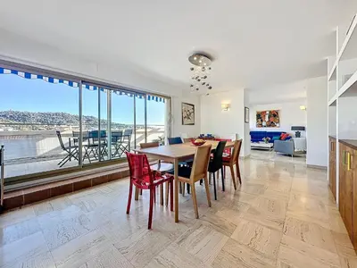 a kitchen and dining room with a table and chairs at Rooftop Grande terrasse Vue mer in Cannes