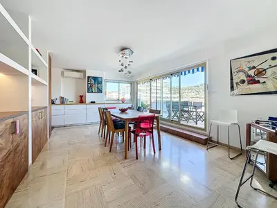 a kitchen and dining room with a table and chairs at Rooftop Grande terrasse Vue mer in Cannes