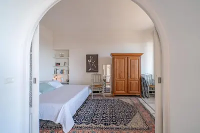 a bedroom with a bed and an archway at Cozystay 1669 Old Port View Elegant 3-Bedroom Apartment in Cannes