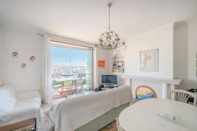 a living room with a couch and a fireplace at Cozystay 1669 Old Port View Elegant 3-Bedroom Apartment in Cannes