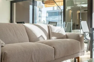 a couch sitting in a room with a window at Magnificent 2 bedroom in the heart of Cannes in Cannes