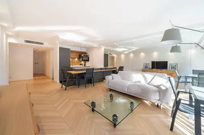 a living room with a white couch and a table at Magnificent 2 bedroom in the heart of Cannes in Cannes