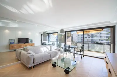 a living room with a couch and a table at Magnificent 2 bedroom in the heart of Cannes in Cannes